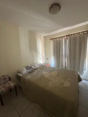 a bedroom with a large bed and a window at Salguero 10 in Cordoba