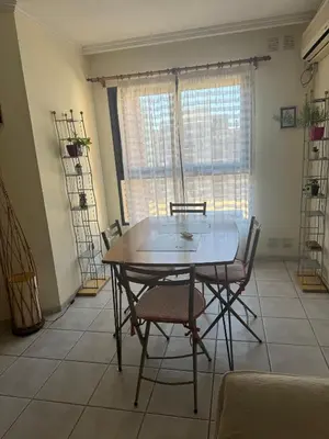 a dining room with a table and chairs in a room at Salguero 10 in Cordoba
