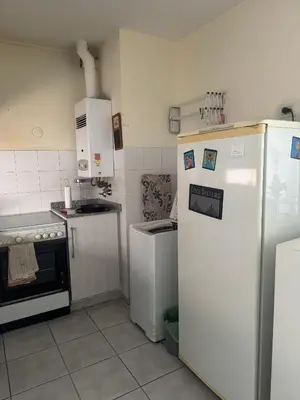 a kitchen with white appliances and a refrigerator at Salguero 10 in Cordoba