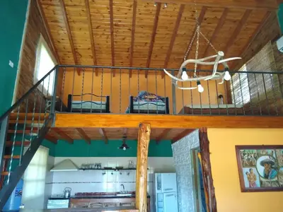 an upper level of a house with a wooden ceiling at Cabaña parque siquiman in Villa Parque Siquiman