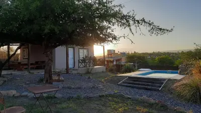 a house with a tree and a swimming pool at Cabaña parque siquiman in Villa Parque Siquiman