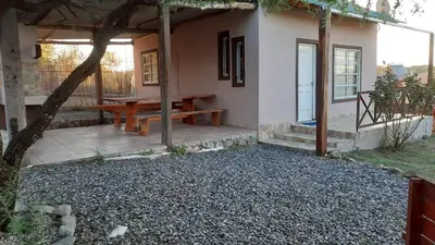 a picnic table in front of a house at Cabaña parque siquiman in Villa Parque Siquiman