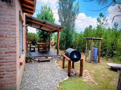 a backyard with a barbecue grill and a patio at Cabañas La Morena in Panaholma