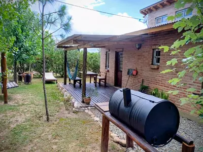 a house with a black tank on a wooden deck at Cabañas La Morena in Panaholma