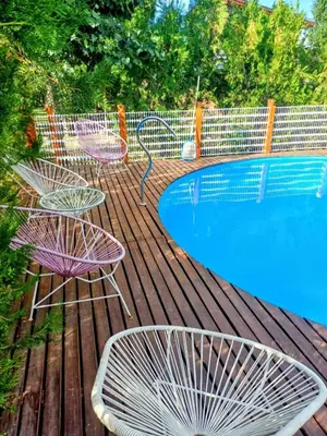 a deck with three chairs and a swimming pool at Cabañas La Morena in Panaholma