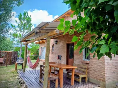 a tiny house with a hammock on a deck at Cabañas La Morena in Panaholma