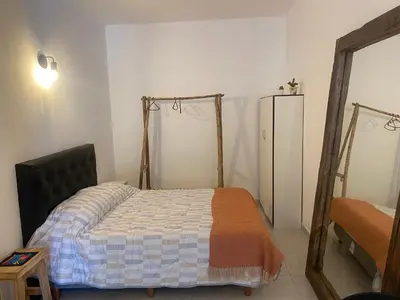 a bedroom with a bed and a mirror at ALOJATE PREMIUM CARLOS PAZ Oasis in Villa Carlos Paz
