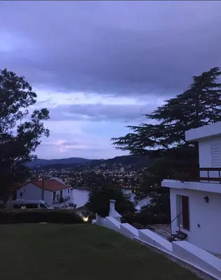 a view of a city from a house at dusk at ALOJATE PREMIUM CARLOS PAZ Oasis in Villa Carlos Paz