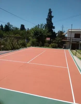 a tennis court with a tennis court at ALOJATE PREMIUM CARLOS PAZ Oasis in Villa Carlos Paz