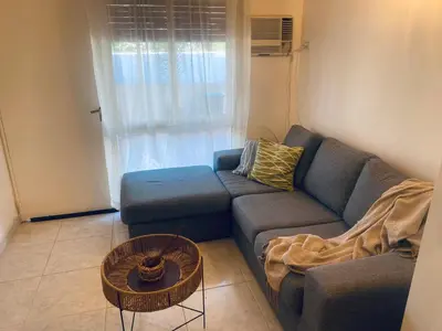 a living room with a blue couch and a table at ALOJATE PREMIUM CARLOS PAZ Oasis in Villa Carlos Paz