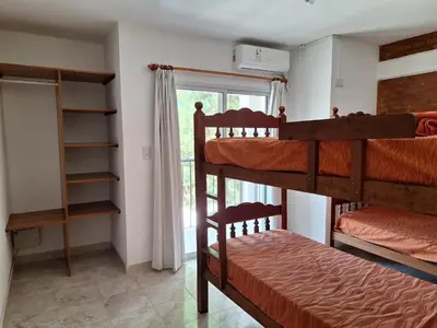 a bedroom with two bunk beds and a window at Cabañas Don Pablo in Mina Clavero