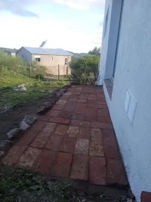 a brick walkway outside of a building at Mountain View & Comfort in Villa Santa Cruz del Lago