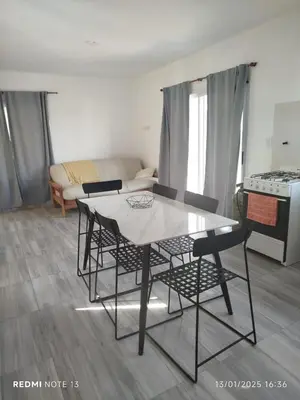 a dining table and chairs in a living room at Mountain View & Comfort in Villa Santa Cruz del Lago