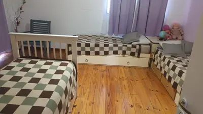 two twin beds in a room with wooden floors at La Casa Del Rio in Villa Santa Cruz del Lago