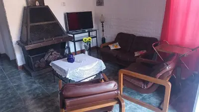 a living room with a couch and a table at La Casa Del Rio in Villa Santa Cruz del Lago