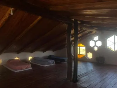 a room with several beds in a attic at Casa de Miel in Los Molles