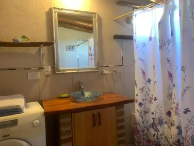 a bathroom with a sink and a mirror at Casa de Miel in Los Molles