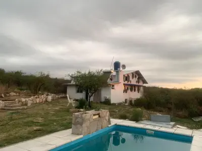 a house with a swimming pool in front of it at Casa de Miel in Los Molles
