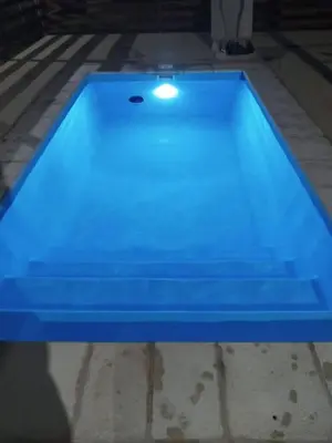 a blue swimming pool in a house at La Calma in Villa Yacanto