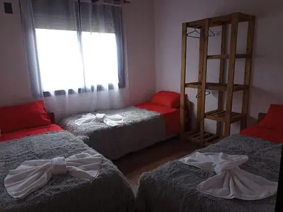 a bedroom with two beds with bows on them at La Calma in Villa Yacanto