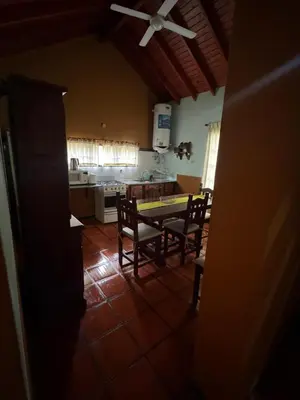 a kitchen and dining room with a table and chairs at Tayimapu in Merlo