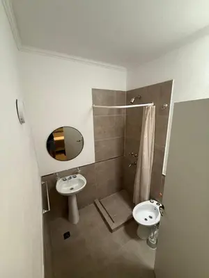 a bathroom with a sink and a toilet and a mirror at Quintaesencia Suites in Mina Clavero