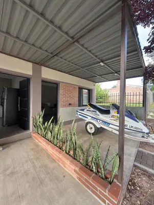 a house with a car parked under a garage at Quintaesencia Suites in Mina Clavero