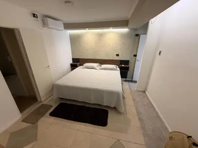 a bedroom with a white bed in a room at Quintaesencia Suites in Mina Clavero