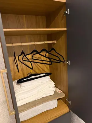 a closet with a rack of towels and a knife at Quintaesencia Suites in Mina Clavero