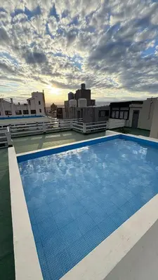 a large swimming pool on the roof of a building at Ailinlduran in Villa Carlos Paz