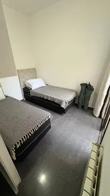 two beds sitting in a room with at Ailinlduran in Villa Carlos Paz
