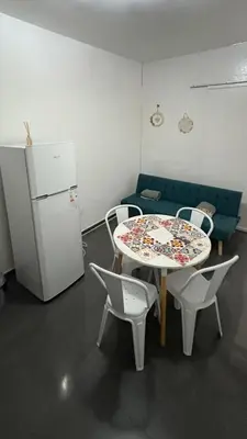 a room with a table and chairs and a refrigerator at Ailinlduran in Villa Carlos Paz