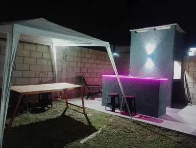 a tent with a table and a cross on a wall at Casa con pileta privada para 5 in Villa Carlos Paz