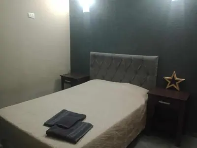a bedroom with a bed with two towels on it at Casa con pileta privada para 5 in Villa Carlos Paz