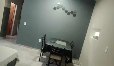 a room with a table with two chairs and a bed at Casa con pileta privada para 5 in Villa Carlos Paz