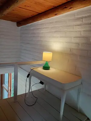 a lamp sitting on a table in a room at El paraíso de Tu Descanso in Villa de Las Rosas