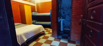 a room with two bunk beds and a checkered floor at Habitación con baño privado en el corazón de Nono in Nono