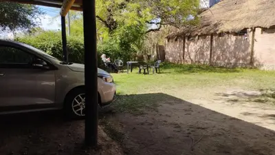 a car parked in a yard next to a house at Habitación con baño privado en el corazón de Nono in Nono