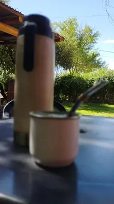 a cup sitting on top of a table with a spoon at Habitación con baño privado en el corazón de Nono in Nono