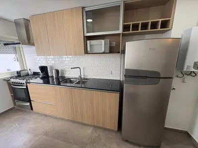 a kitchen with a refrigerator and a sink at Departamento amplio para 6 personas Zona Centro in Cordoba