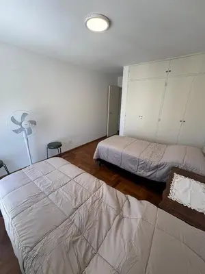 a bedroom with two beds and a fan at Departamento amplio para 6 personas Zona Centro in Cordoba