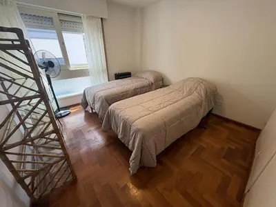two beds sitting in a room with a staircase at Departamento amplio para 6 personas Zona Centro in Cordoba