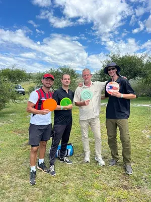 a group of people holding frisbees in a field at Sauron Adventure in Cuesta Blanca