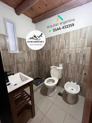 a bathroom with a toilet and a sink at Monoambientes comechingones in Villa Cura Brochero
