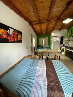 a bedroom with a large bed in a room at Monoambientes comechingones in Villa Cura Brochero