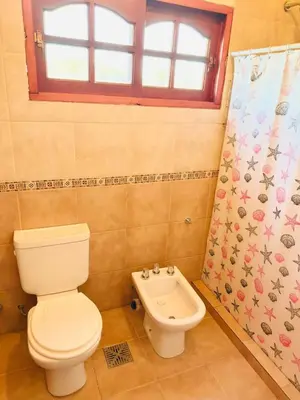 a bathroom with a toilet and a shower curtain at Altos de ensueños in Alpa Corral