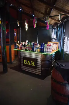 a bar in a room with a lot of drinks at Parada 14 in Cavalango