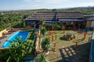an aerial view of a resort with a playground at Parada 14 in Cavalango