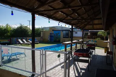 a patio with a fence and a swimming pool at Parada 14 in Cavalango