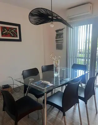 a dining room with a glass table and chairs at Vive Carlos Paz in Villa Carlos Paz